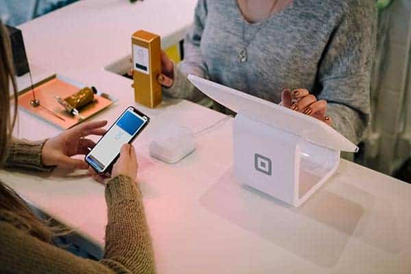 9-ecommerce-SEO-tips-that-work-in-2021-woman-paying-with-square-clio-websites