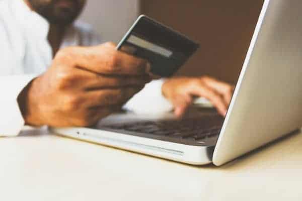 best-practices-for-nonprofit-websites-donate-man-with-credit-card-and-laptop