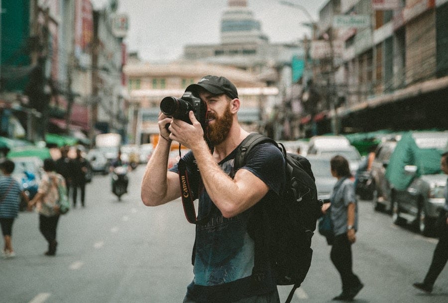 best-website-builder-for-photographers-man-taking-a-photograph-clio-websites