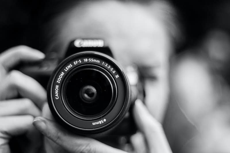 best-website-builders-for-photographers-woman-photographer-camera-close-in-clio-websites