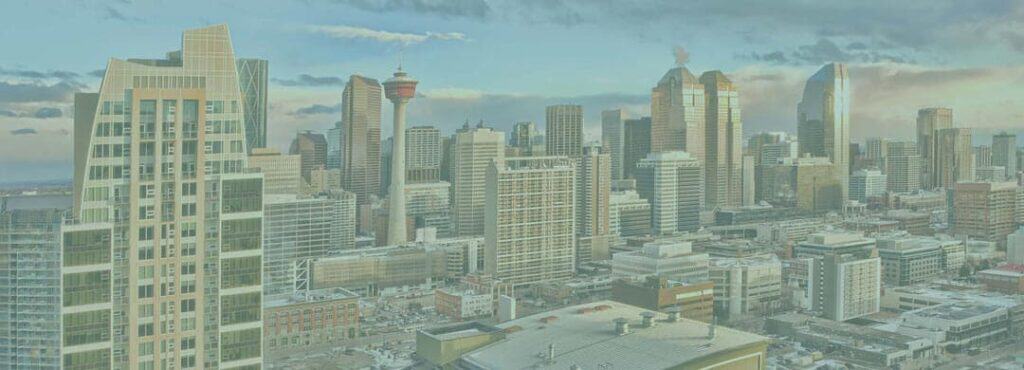 A city skyline with modern high-rise buildings under a partly cloudy sky, featuring a distinctive red observation tower among the skyscrapers—perfect for showcasing your WordPress and WooCommerce website themes. - Clio Websites | Top Canadian Web Design Company