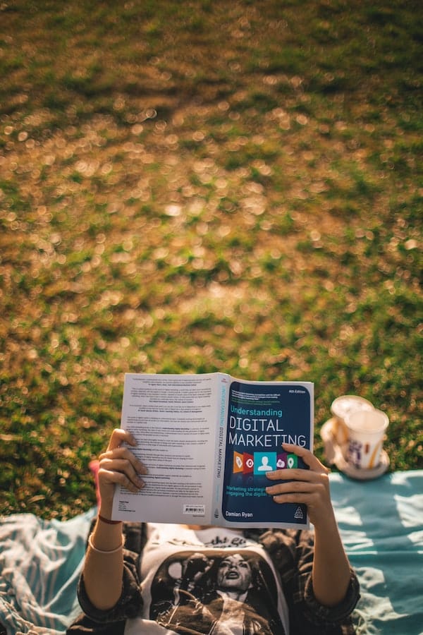 person-reading-a-digital-marketing-book-clio-websites