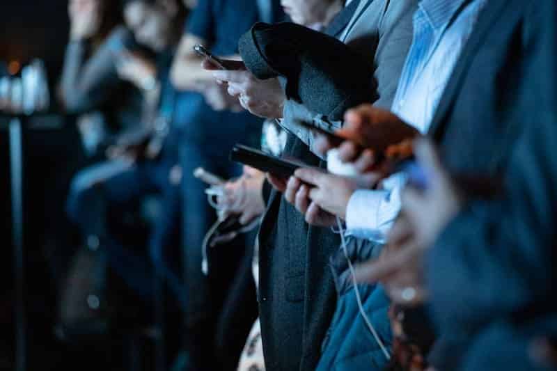 social-media-marketing-tips-people-using-socials-on-phone-clio-websites