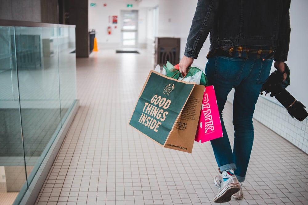 UX Design for E-commerce - man walking with shopping bags