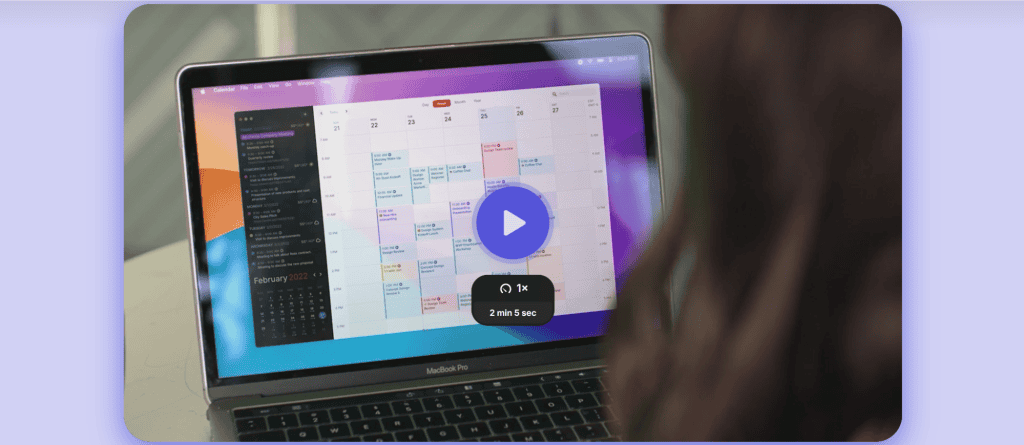 A person is viewing a MacBook Pro showcasing a color-coded February 2023 calendar. Overlayed on the screen is a play button for a brief, 2-minute and 5-second video. This scene serves as perfect website inspiration, highlighting innovative features often seen in SaaS examples. - Clio Websites | Top Canadian Web Design Company