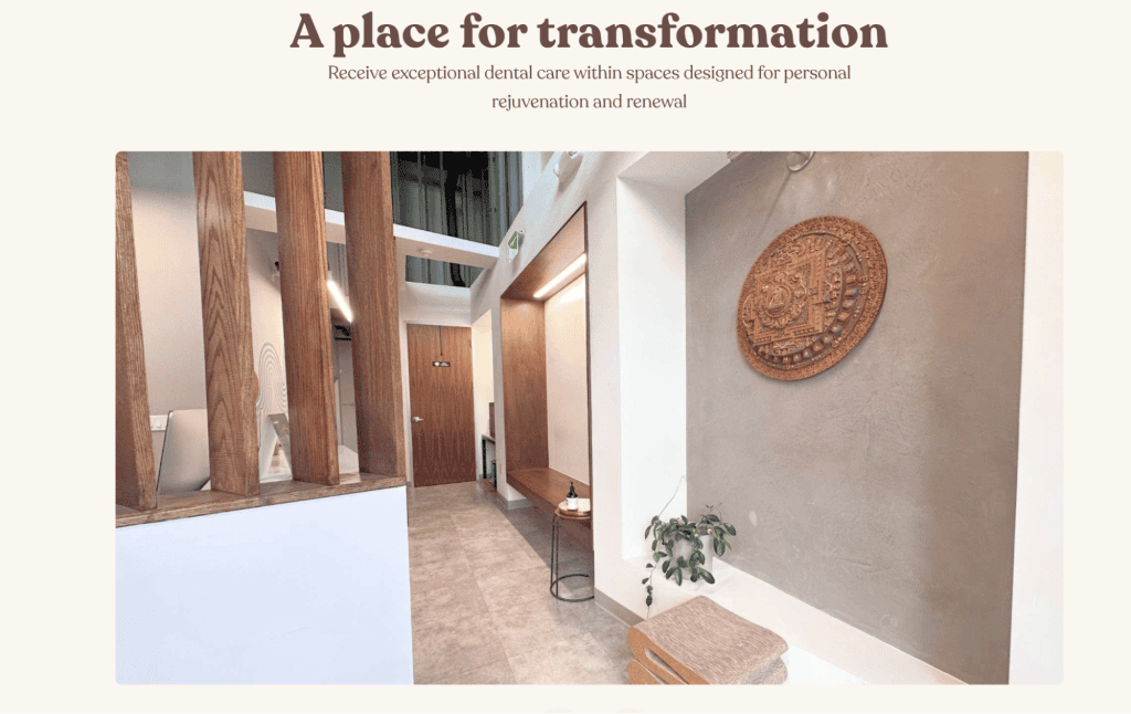 Modern dental office interior with wooden accents and a decorative wall piece. A hallway and seating area are visible, enhanced by natural light pouring in. The text at the top reads, "A place for transformation," echoing the elegance of the best dental websites in design sophistication. - Clio Websites | Top Canadian Web Design Company