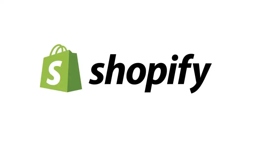 Shopify logo featuring a green shopping bag with a white "S" next to the word "shopify" in bold, black lowercase letters on a white background, representing one of the leading Website Builders. - Clio Websites | Top Canadian Web Design Company