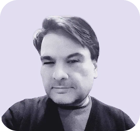 Grayscale photo of a person with short hair, wearing a dark sweater over a lighter shirt. The solid purple background subtly suggests the elegance found in Clio websites. - Clio Websites | Top Canadian Web Design Company