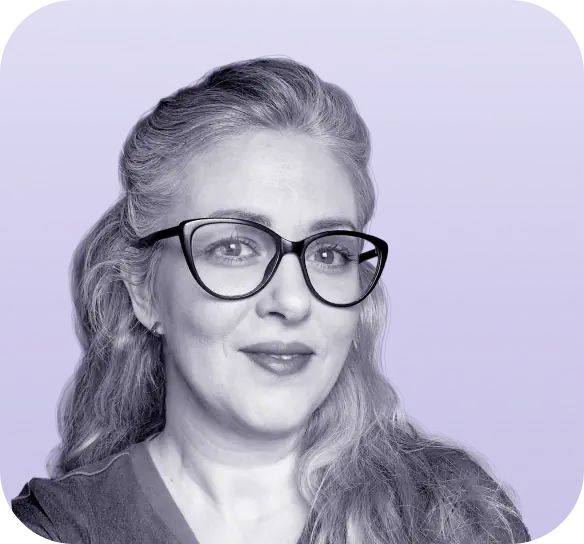 A person with long hair and glasses smiles slightly against a purple background, reminiscent of the classic black-and-white style often seen in vintage Clio websites. - Clio Websites | Top Canadian Web Design Company